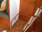 Doors to access storage space under the wet locker and at end of starboard settee. Meridian, 139